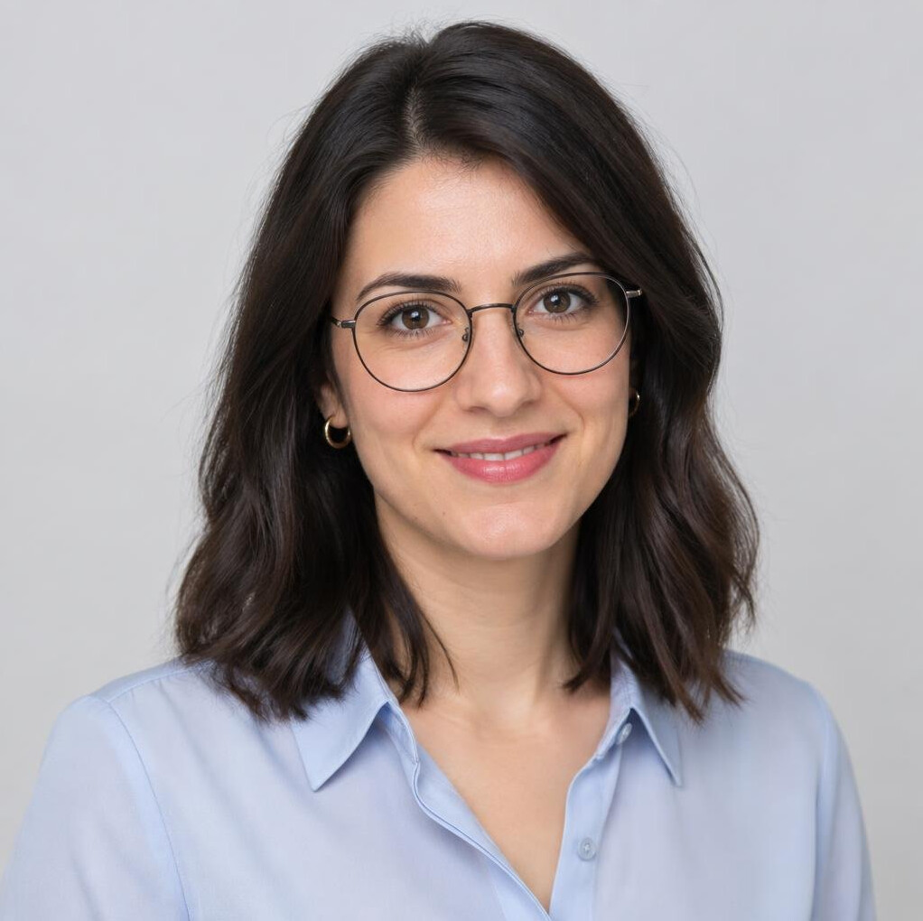 Studio portrait of a young Croatian woman with glasses smiling