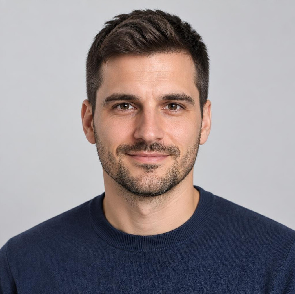 Studio portrait of a young Croatian man with a beard smiling